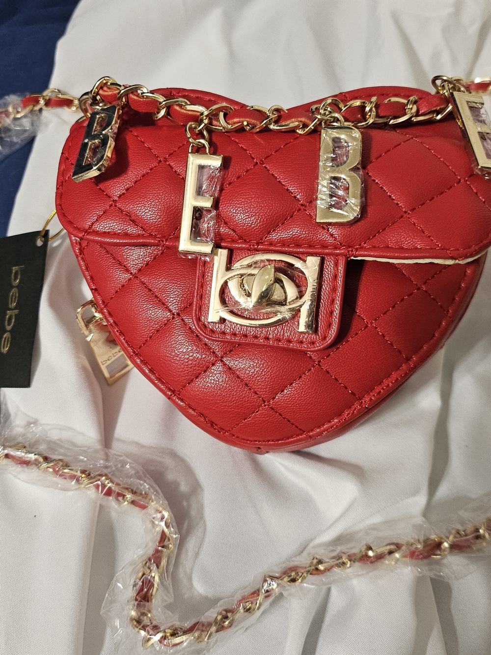 BEBE Quilted Red Heart Crossbody Bag with Gold Charm Accents